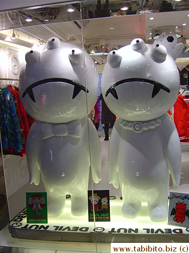 A pair of strange dolls in the window of a shop in Chungking Mall